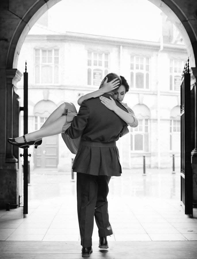 A man carries a woman