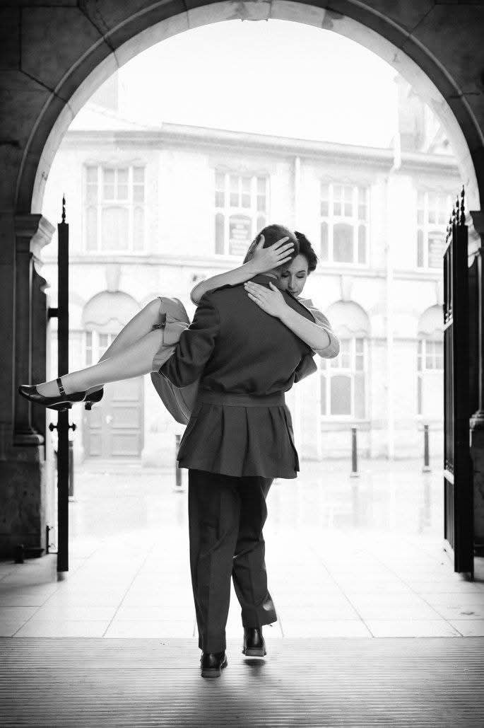 A man carries a woman