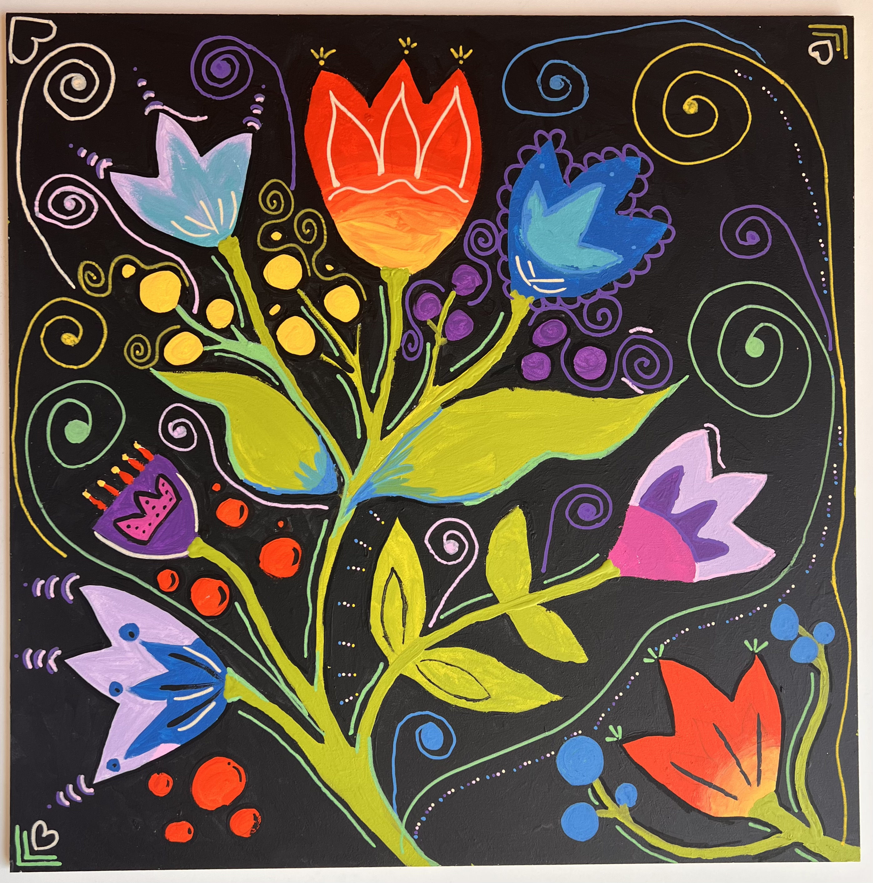 Colourful flowers on a black background to symbolise freedom.