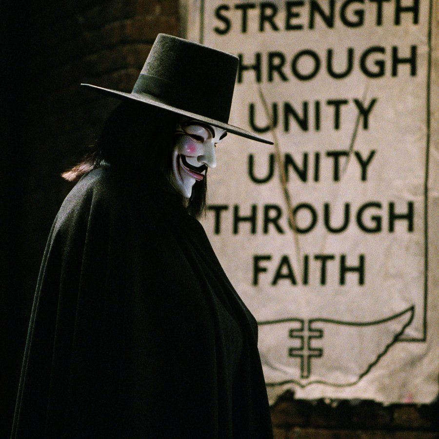 Still from the film V for Vendetta. A masked figure in black