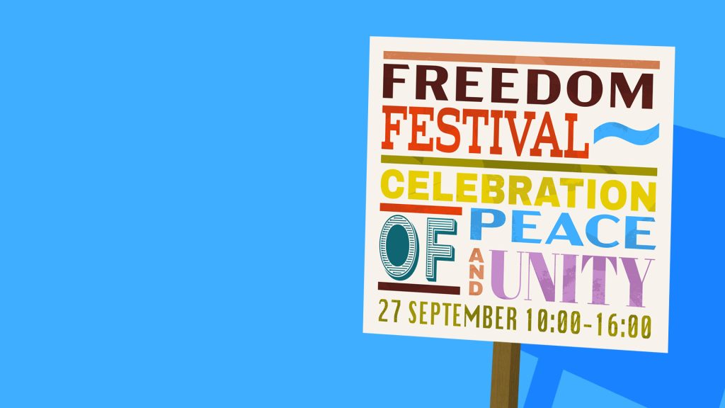 Illustrated poster on a blue background reading: ‘FREEDOM FESTIVAL – CELEBRATION OF PEACE AND UNITY – 27 September 10:00–16:00.’ The words are displayed in bold