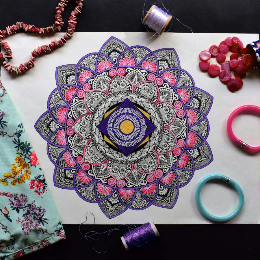 An Indian mandala surrounded by textiles and beads