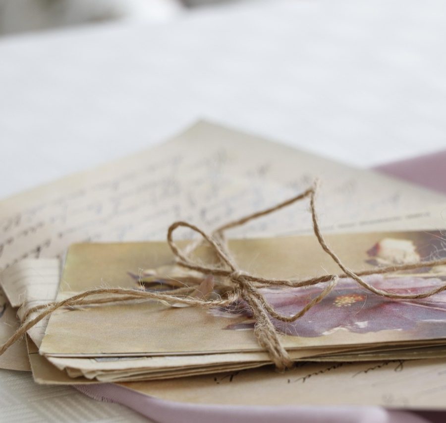 A small pile of old photos and documents tied together with string