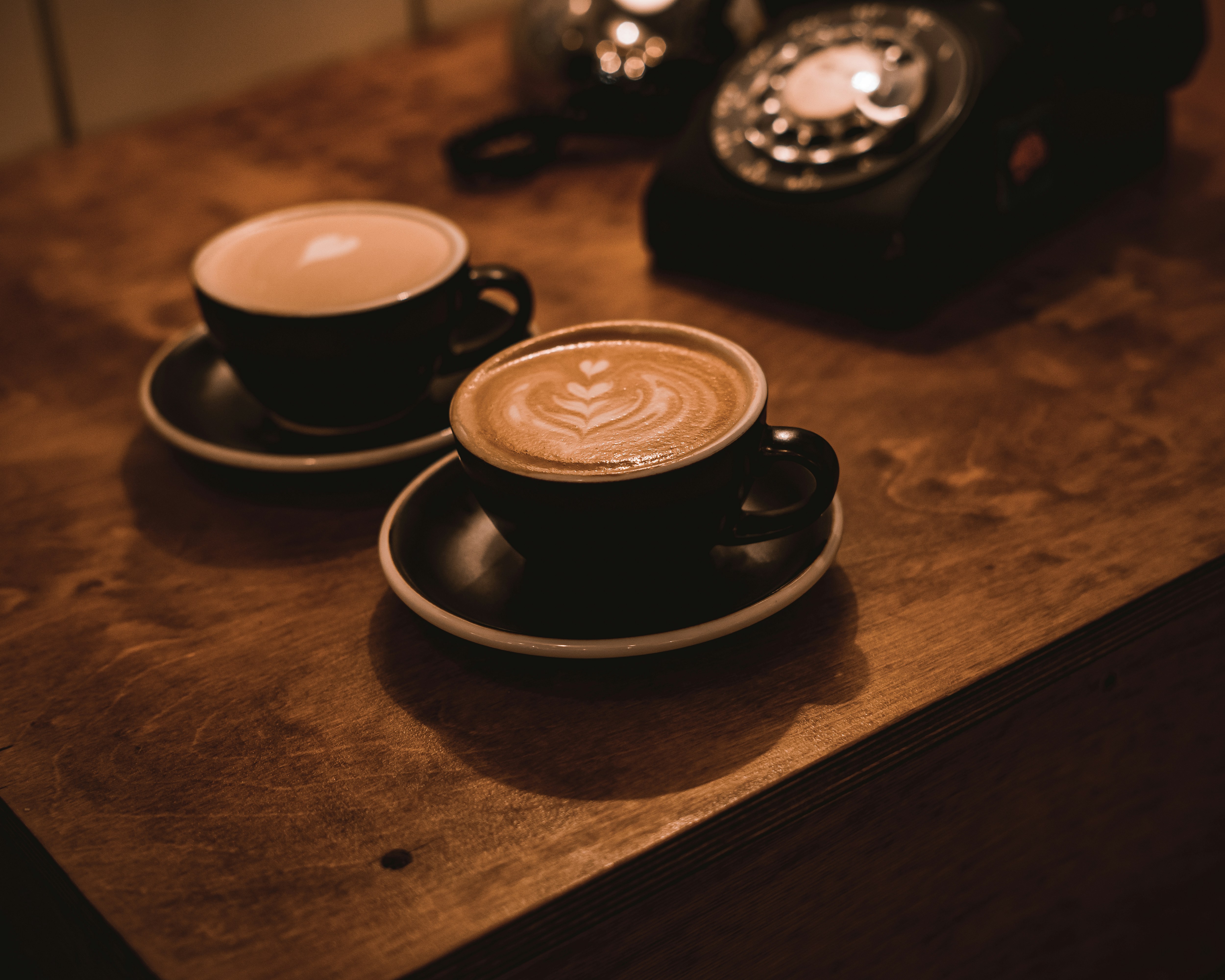 Cups of coffee with patterns on the foam